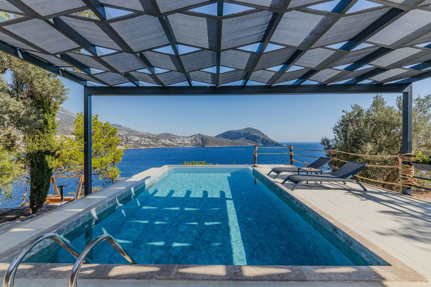 A view of a pool with a modern metal sunshade